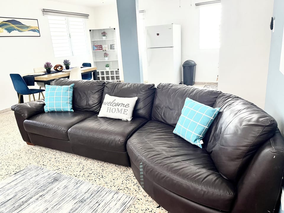 The living room is bright and airy with large, comfy sofa and  Smart TV.