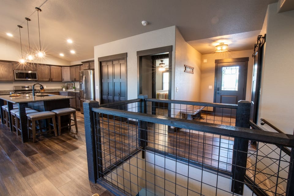 Gather in the open kitchen and make it your base of operations — snacks, coffee, and the whole group in the same conversation before the day starts.