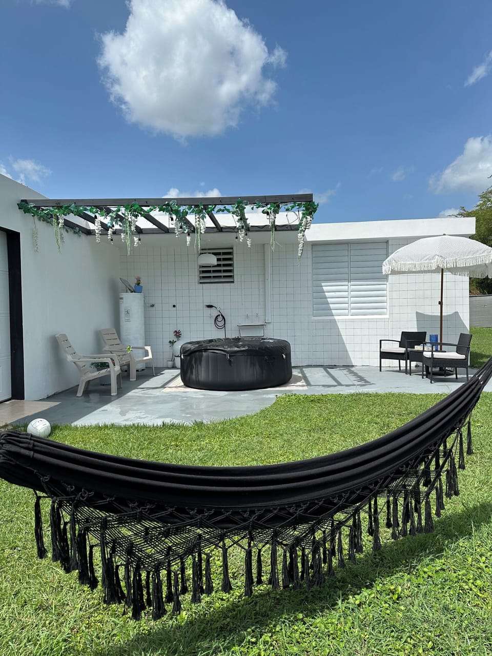 Private jacuzzi and shaded outdoor lounge perfect for relaxing.