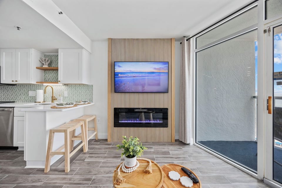 Relax in the cozy family room featuring a built-in electric fireplace. 