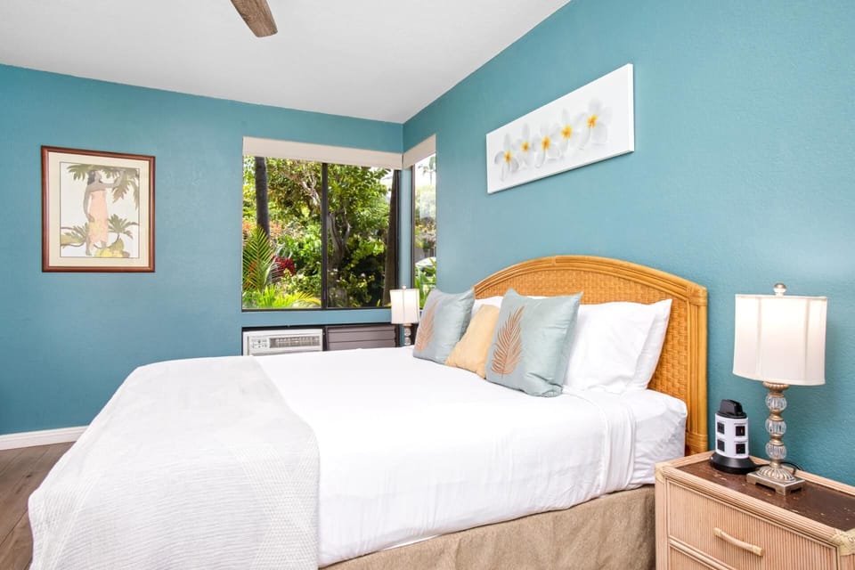 The master bedroom features vibrant island decor and soft natural light