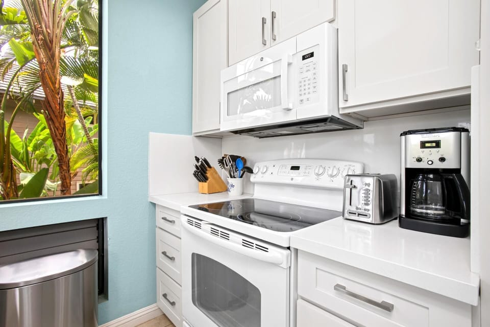 Kitchen stocked with essentials including full-size appliances and coffee maker