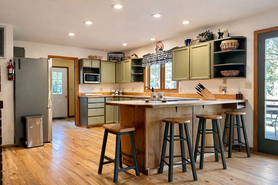 Your fully equipped kitchen invites culinary adventures with rustic charm, modern appliances, and a breakfast bar perfect for morning coffee conversations.