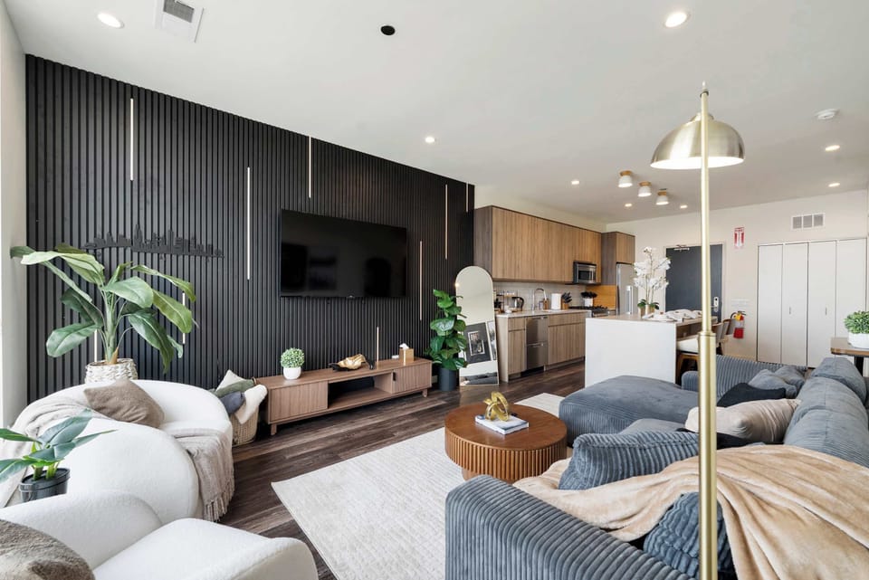 Stylish living room w/ layered textures, modern decor, & a welcoming layout.