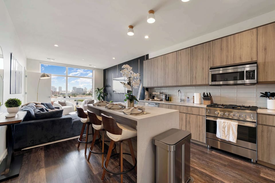 Open kitchen & dining area w/ clean lines, ample counter space, & a polished, contemporary feel.