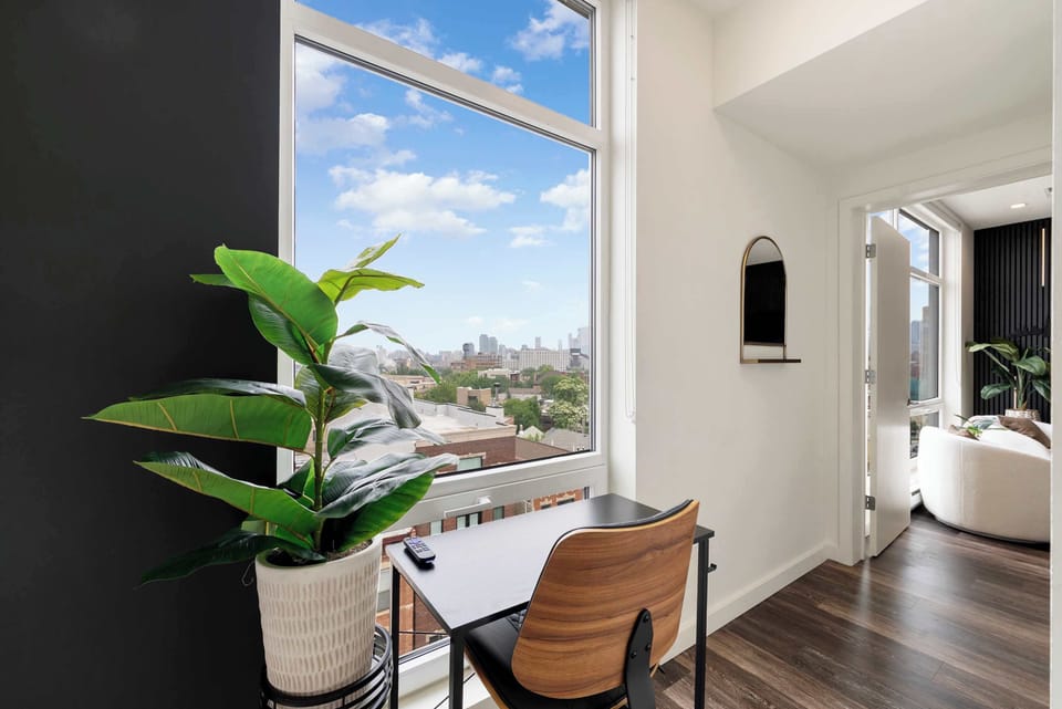 Bright study nook w/ natural light, greenery, & a clean setup for focused work.