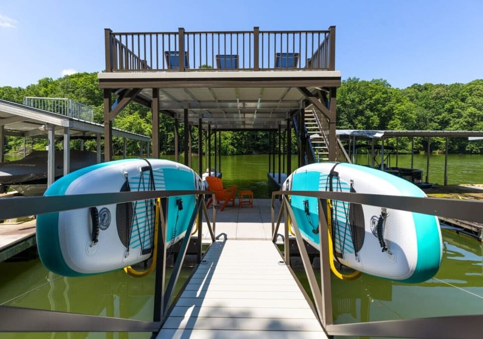 Your dock with 2 paddleboards, 2 kayaks, slip, and top deck for lounging and views