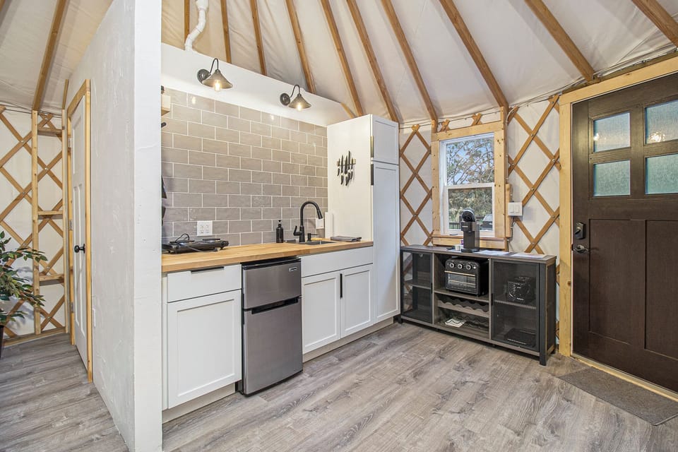 Red yurt kitchen with hot plate and Keurig coffee maker