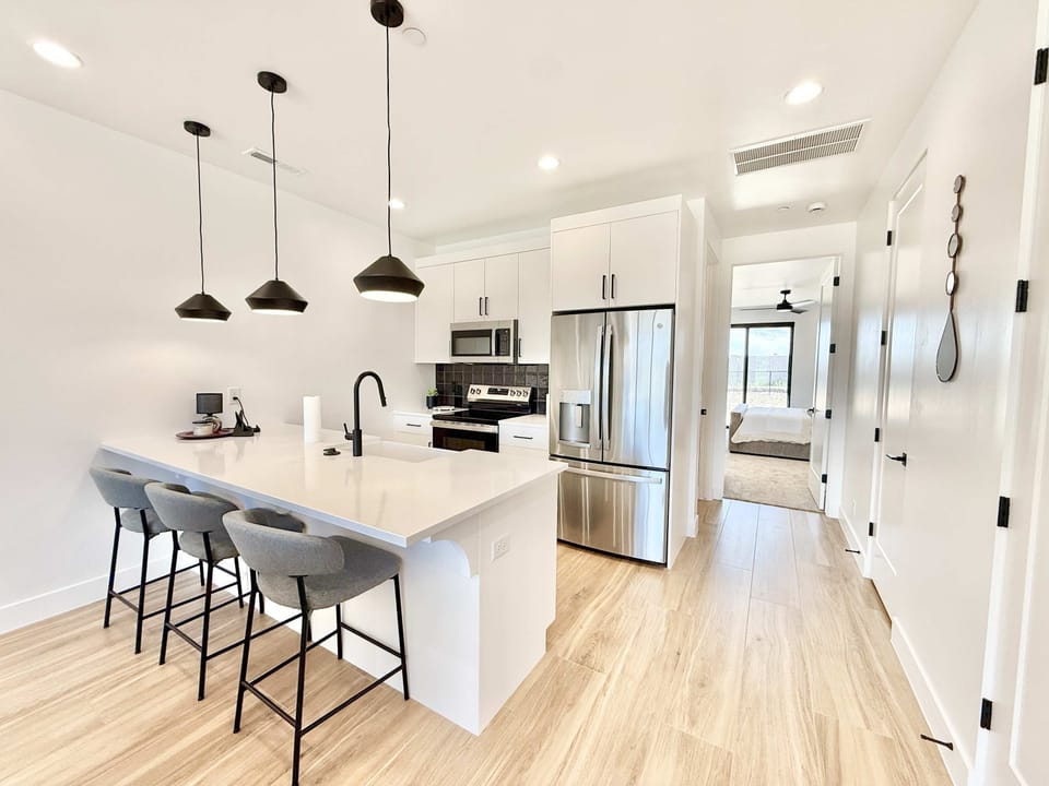 Chic pendant lighting & spacious island make this gourmet kitchen perfect for breakfast before hiking or dinner in