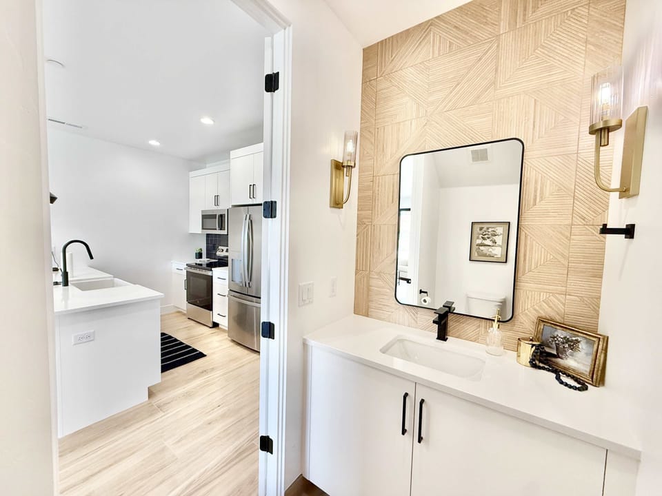 Upscale half bathroom with stylish tile & modern fixtures