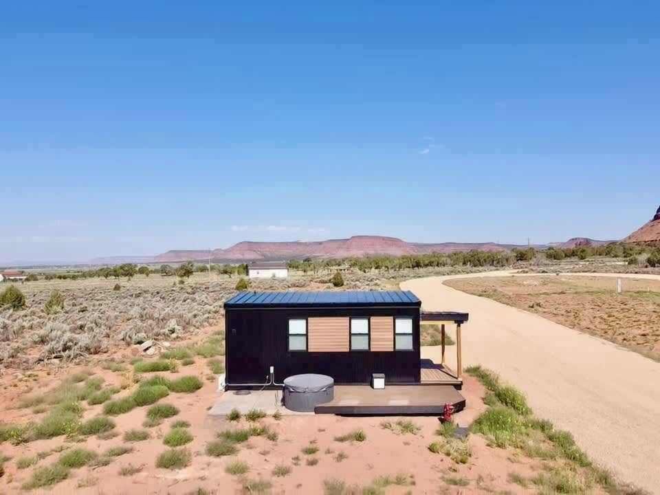 Journey Pines cabin sits alone amid Kanab's high desert, with red mesas and wide-open sky as your backdrop.