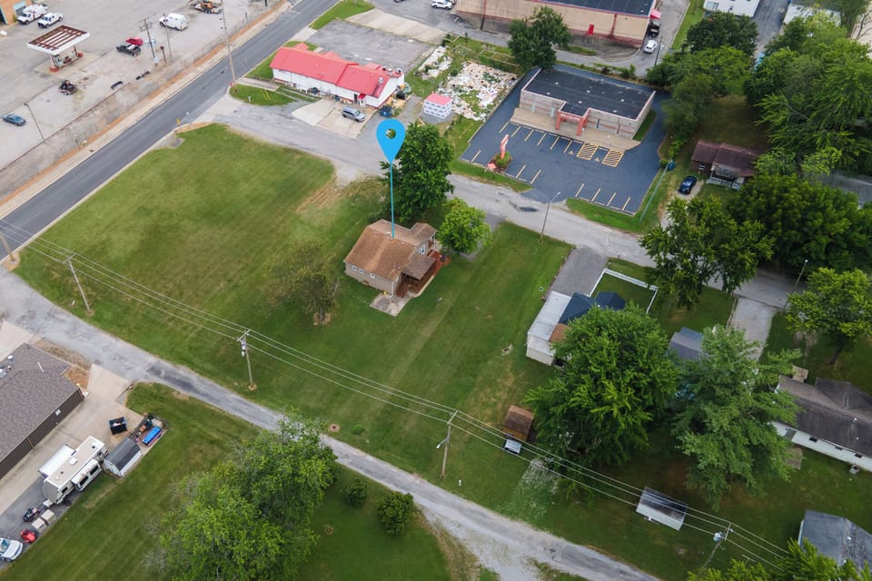 Room to relax, close to everything. Aerial views show a comfortable distance from neighbors, with the heart of town just minutes away.