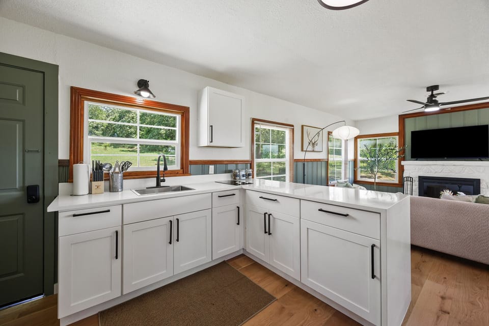 Modern kitchen with everything you need, surrounded by natural light and views of the outdoors