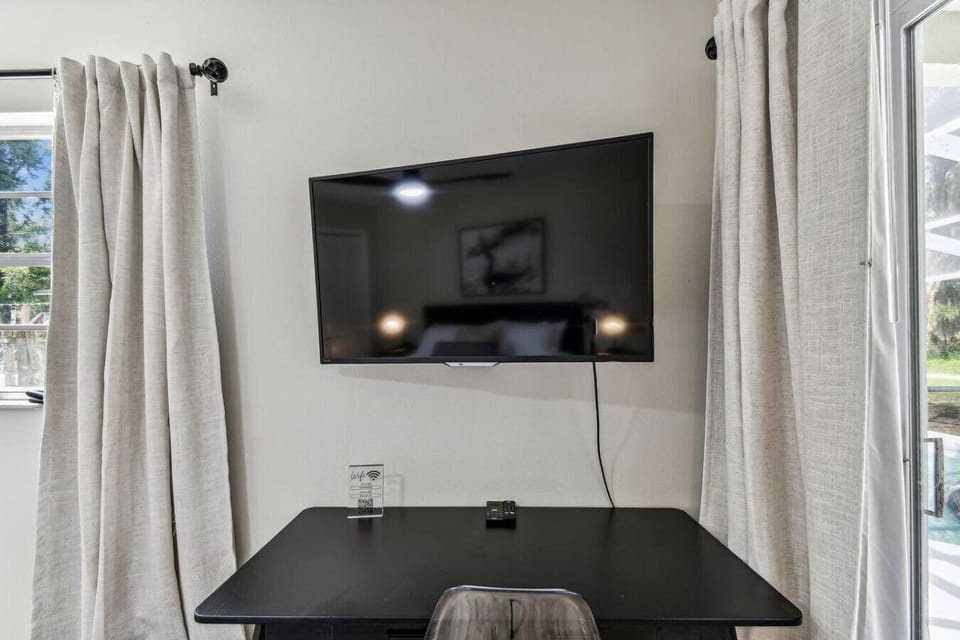 Work Space: Bright desk area with sleek TV and quick Wi-Fi for effortless remote working fun!