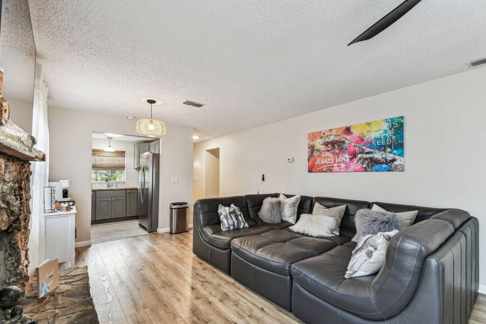 Living Room: Modern elegance with a stylish sectional and vibrant art for your relaxation!