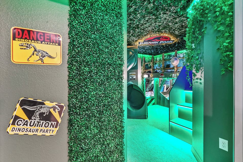 Step into a whimsical adventure filled with vibrant green accents and playful dinosaur decor that delights guests of all ages. The textured walls and fun signage create an immersive atmosphere for unforgettable family fun.