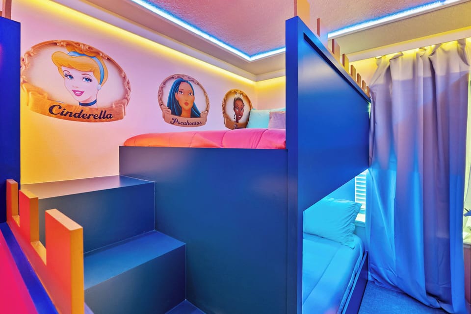 Enjoy a charming children's retreat featuring a vibrant blue bunk bed adorned with favorite character murals. The enchanting lighting sets a magical mood for fun nights and restful sleep after exciting days.