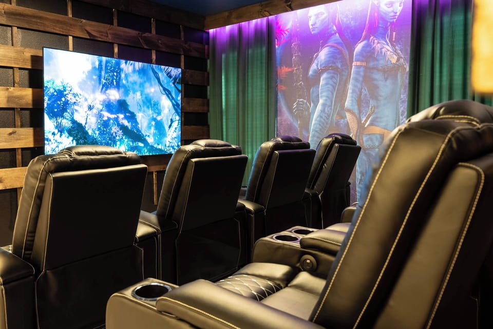 Enjoy a cinematic experience in comfy black recliners, perfectly arranged for movie nights. With vibrant decor and soft purple lighting, you’ll love unwinding and immersing yourself in your favorite films.