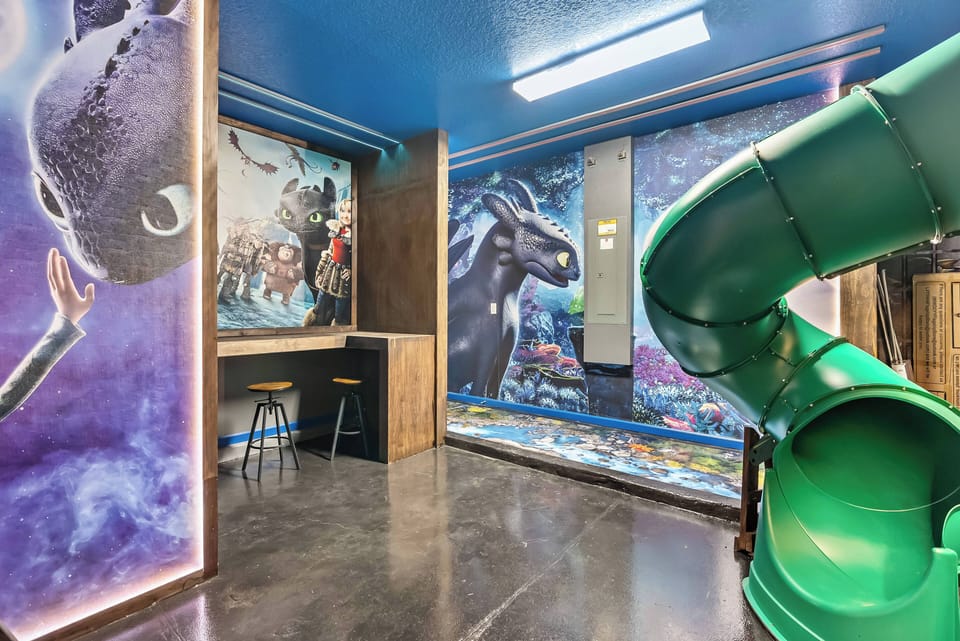 Step into a playful haven with vibrant murals and a fun green slide, perfect for kids and the young at heart. The polished concrete floor and sleek lighting create a lively atmosphere, making every moment feel extraordinary.