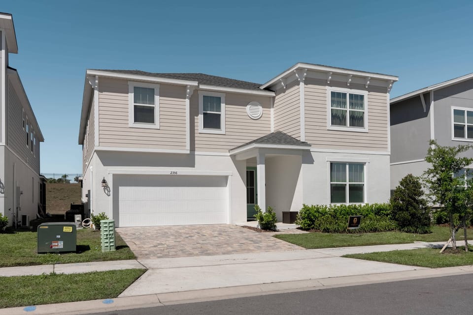 This charming home welcomes you with light-colored siding and an inviting front porch, perfect for your stay. The beautifully landscaped yard boosts curb appeal, ensuring a delightful outdoor experience awaits you.
