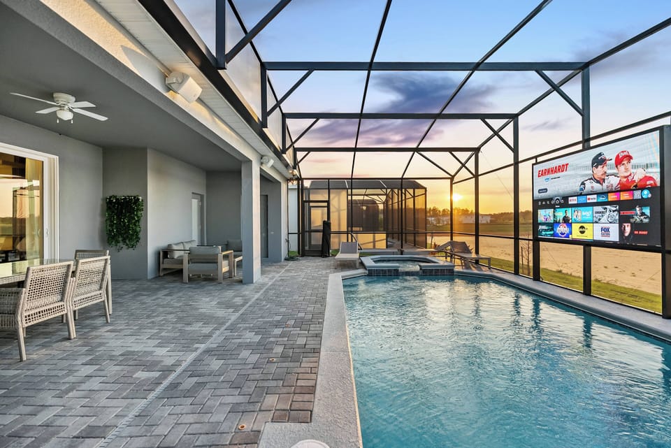 Step into your private oasis, where a shimmering pool and stunning sunset await. Enjoy the sleek paver stone patio, cozy seating, and a large screen for entertainment, creating the perfect ambiance for relaxation and unwinding.
