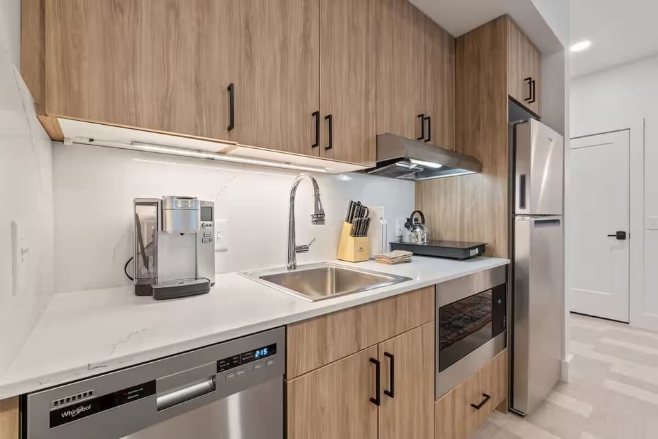Start mornings with espresso in this sleek, modern kitchen.