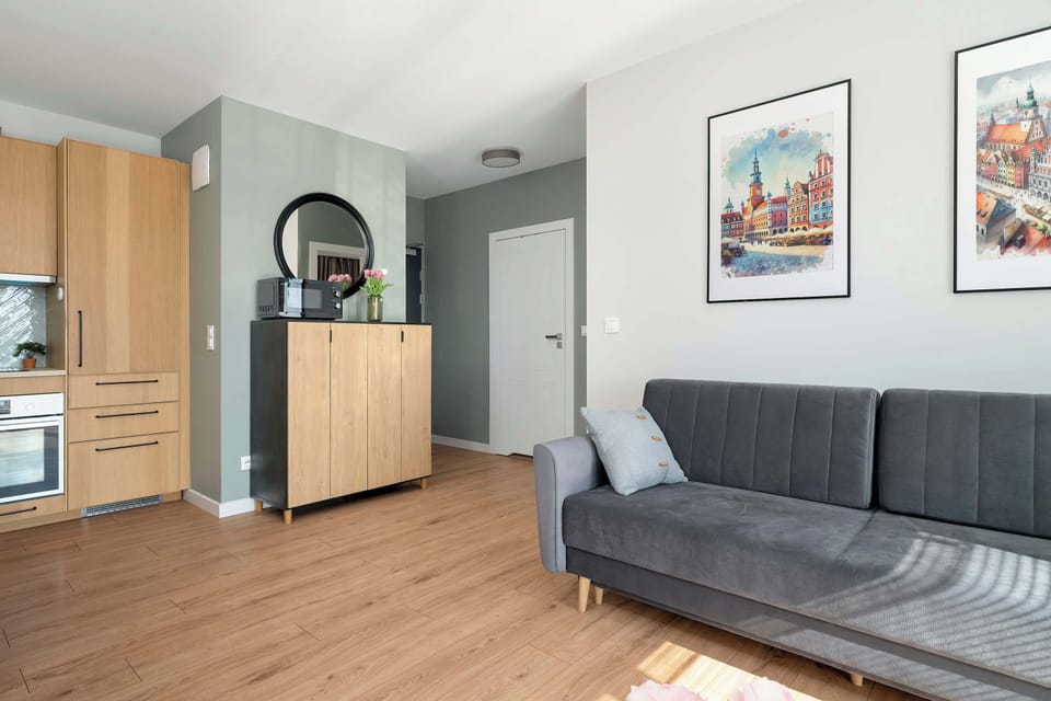 The modern hallway flows seamlessly into the living room, setting the tone for the apartment’s style.