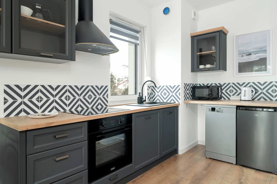The sleek design of the kitchenette blending seamlessly with the living area.