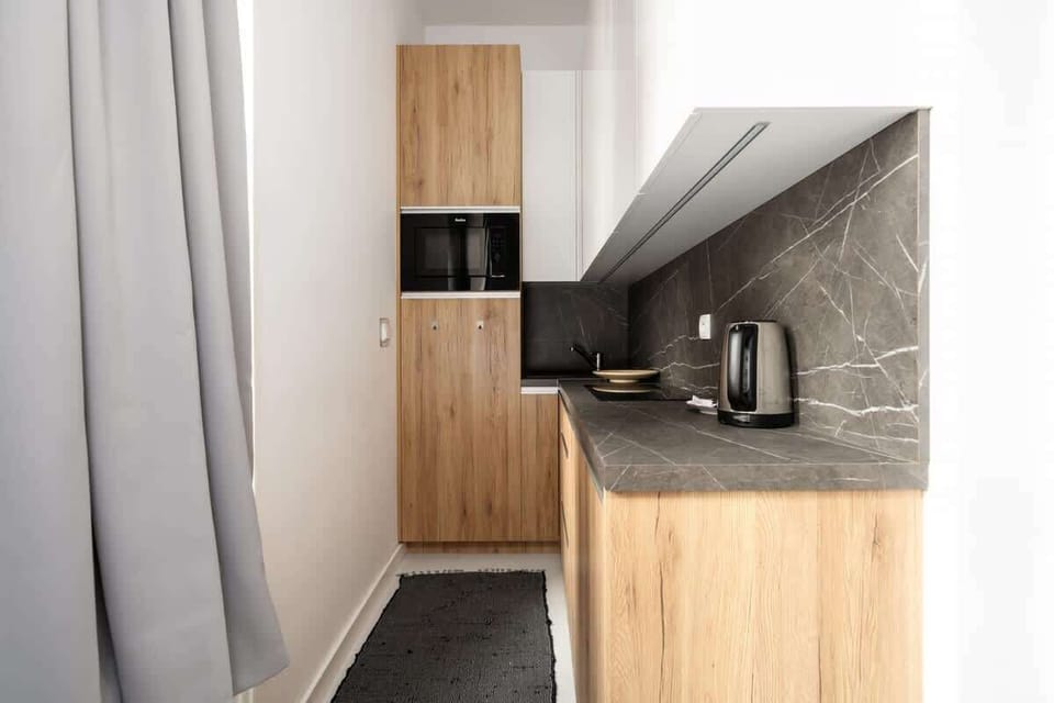 Close-up of the kitchenette with a view of the countertop and essential appliances for added convenience.

