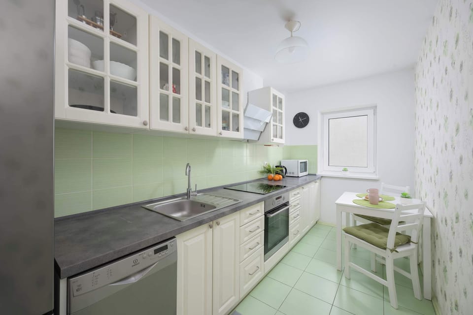 Kitchen with plenty of kitchen utensils and dishes. 