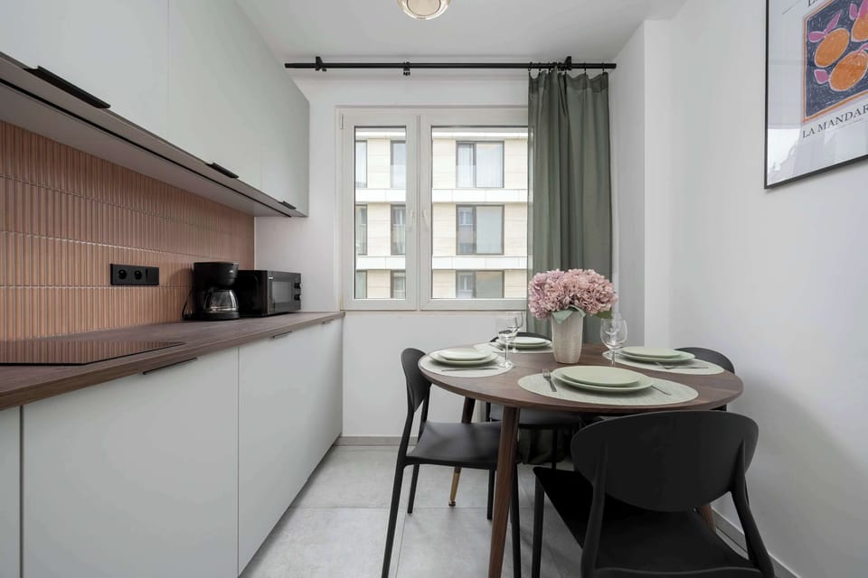 The kitchen's sleek design includes all necessary cookware and utensils.