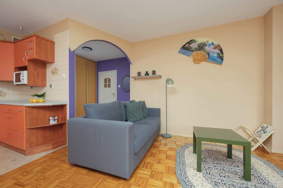 Living room with a two sofa beds (double and single), TV and coffee table.