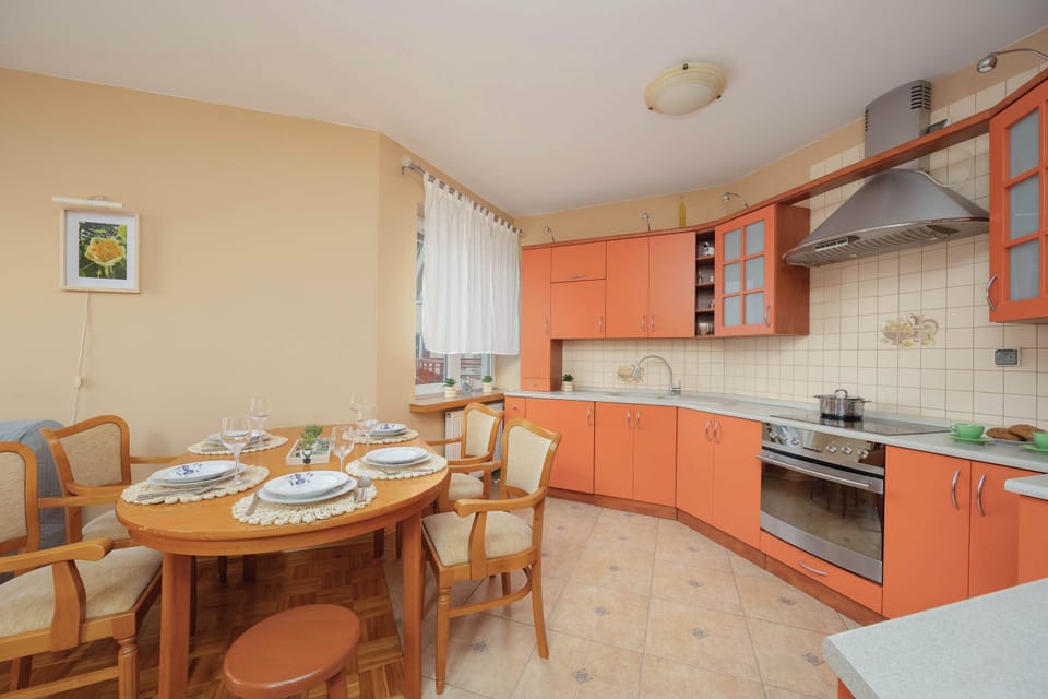 Fully equipped kitchenette with electric cooktop, oven, microwave, electric kettle, refrigerator with freezer and dining area.