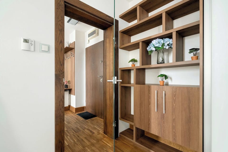 A stylish built-in wardrobe with wooden accents offers ample storage space. Its minimalist design blends harmoniously with the elegant interior.