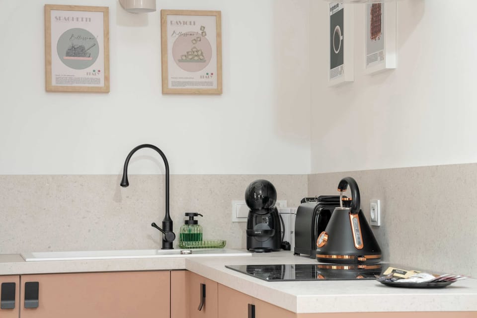 Kitchenette with oven and refrigerator. 
