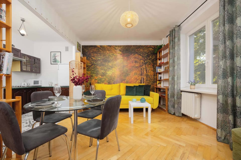 The living room is equipped with a comfortable double sofa bed and a practical dining table.