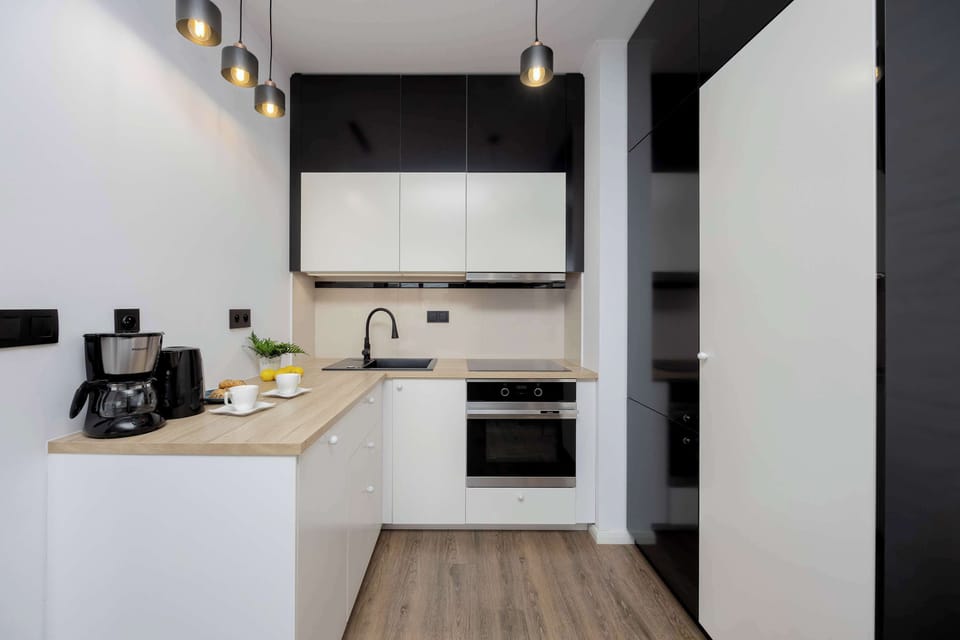Another view of the kitchen, showing its modern layout, clean lines, and a connection to the dining and living spaces.