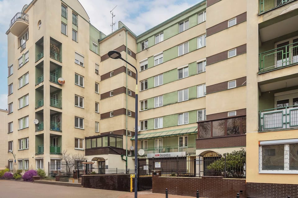 A street view with residential buildings featuring classic architecture.