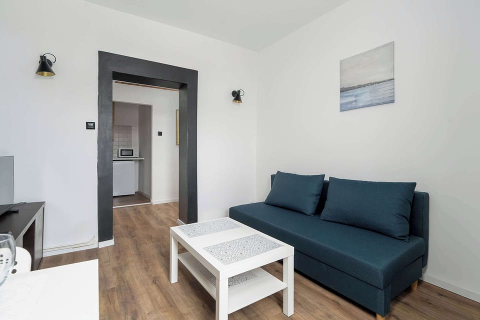 A perspective that connects the living room to the adjacent hallway, emphasizing the open layout and spacious feel.