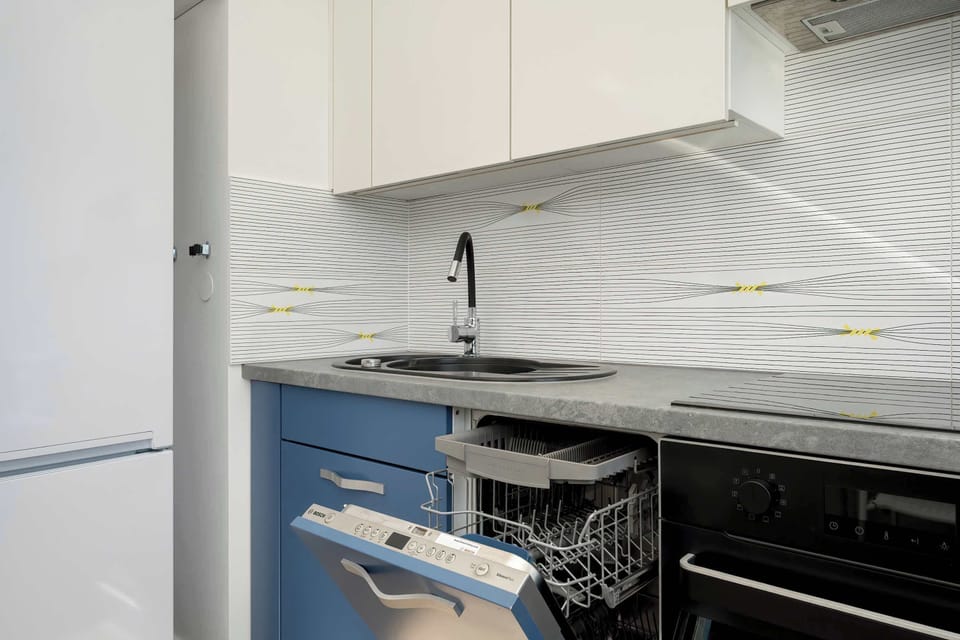The same kitchen from a different perspective, with built-in appliances and a functional cabinet layout.
