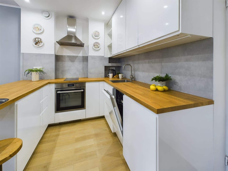 Open concept kitchen and living room area, showcasing a sleek design.