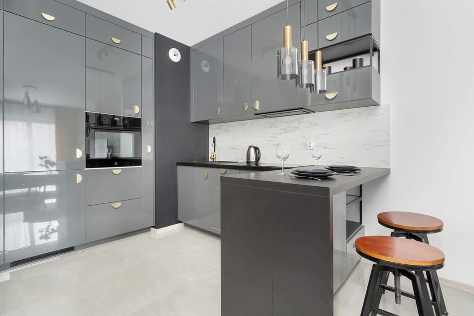 A more detailed view of the kitchen, highlighting its modern design, compact yet functional layout, and minimalistic decor.