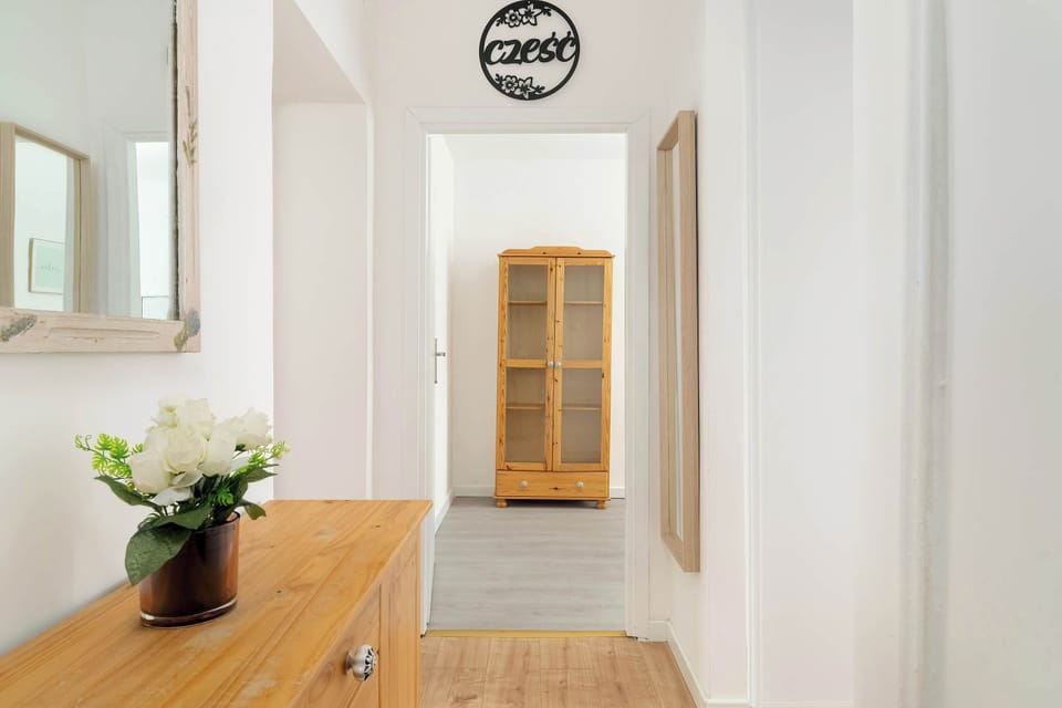 Hallway with mirror and chest of drawers.