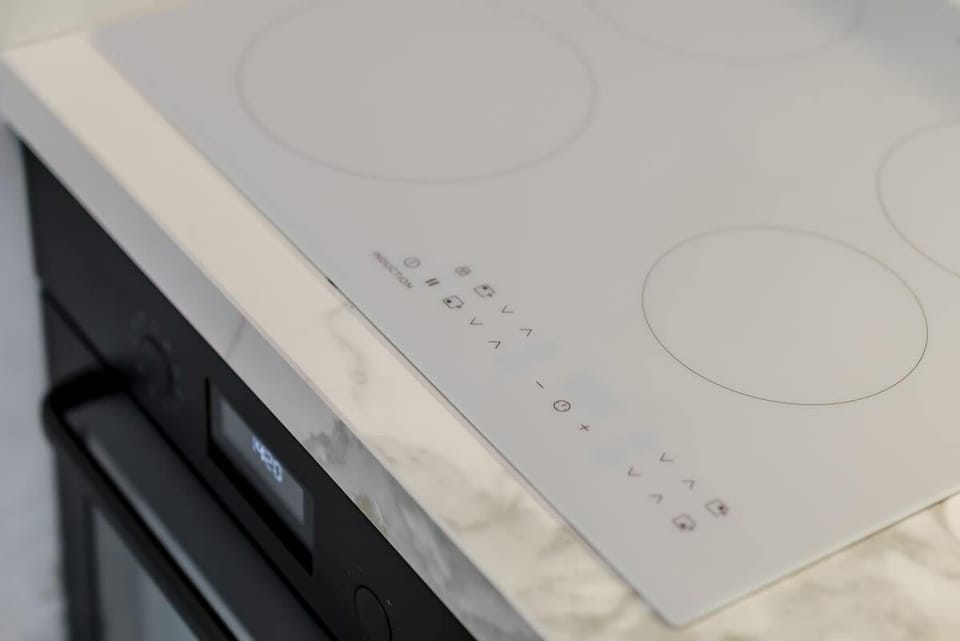 A close-up of an induction cooktop with clear, clean lines.