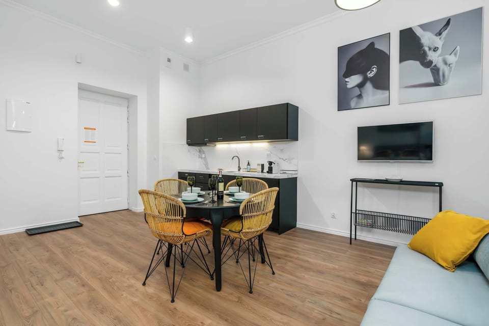 A broader view of the living room with the sofa, coffee table, and adjoining areas.