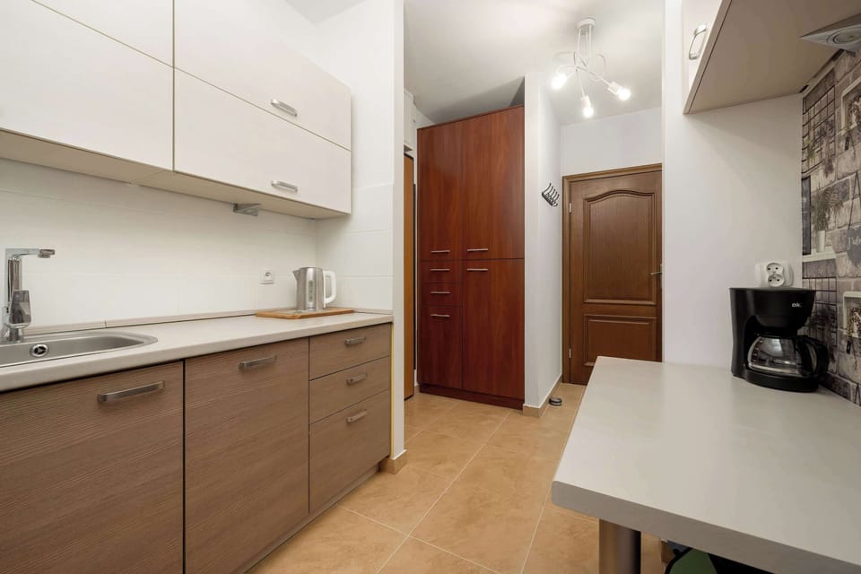 Kitchen with plenty of kitchen utensils and dishes. 