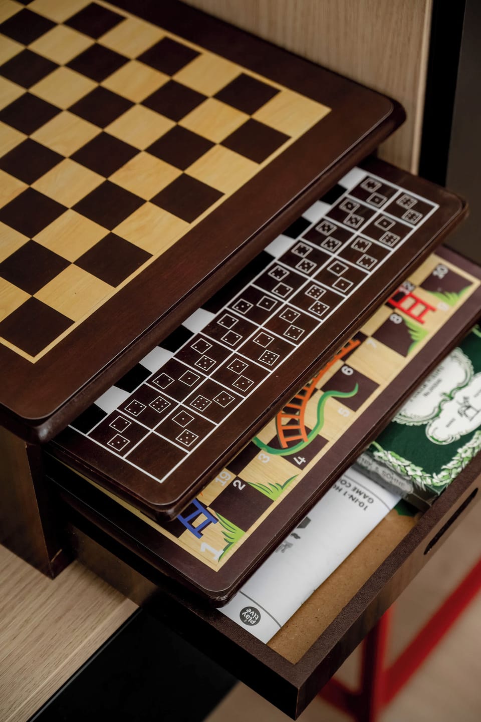 13. A bedroom shelf that opens to reveal a neatly stored chess set, adding a touch of entertainment and thoughtful design.
