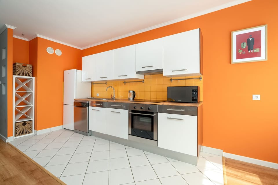 A nearly identical kitchen shot, viewed from the opposite angle, showing more counter space and appliances.