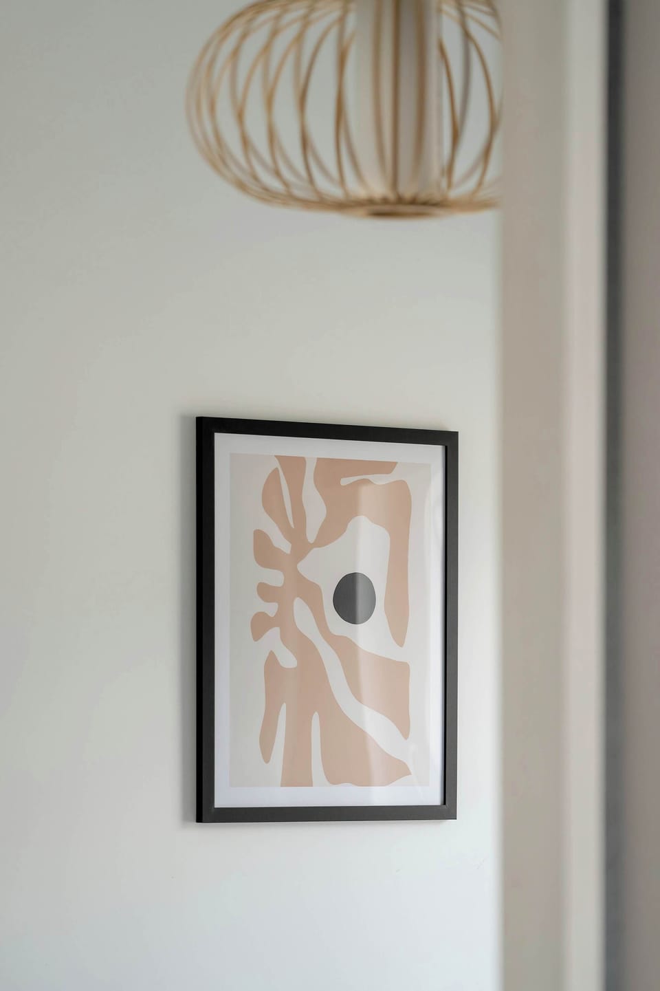 A soft-toned print and delicate lamp warm up the space, adding an artistic touch.

