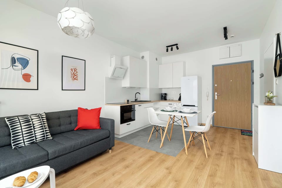 A living room with designer touches and colorful cushions adds personality to the interior.

